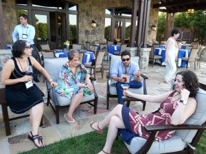 April Christiansen, Caitlin Pryor, Chad Abushanab, and Annie Rudy composing a limerick while Alice McDermott passes by in the background